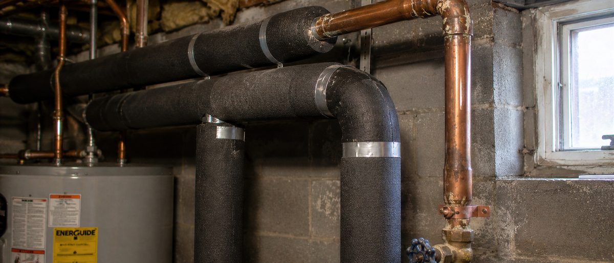 Insulated copper plumbing and a water heater in an unfinished space